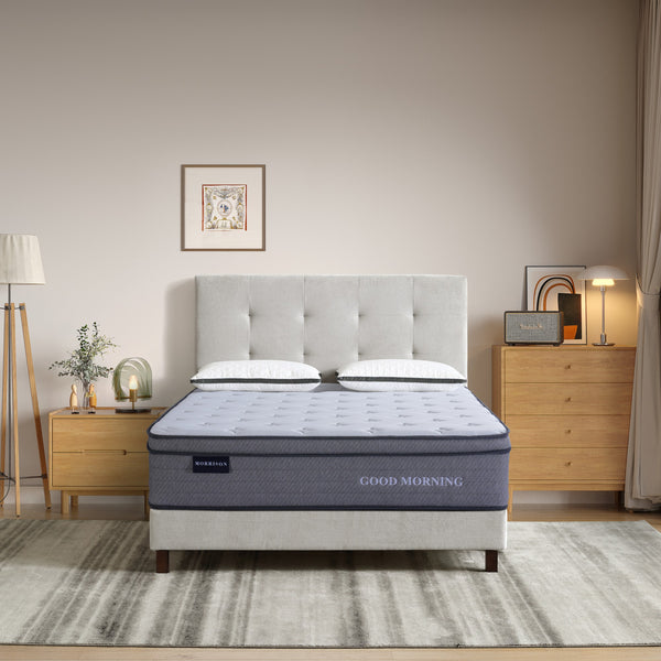 Bedroom with a 'Morrison' 'Good Morning' mattress on display, flanked by nightstands and a lamp.