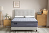 Gray mattress with 'Morrison' and Good Morning' branding in a bedroom setting.