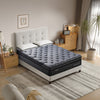 Gray mattress on a bed in a bedroom setting with decor elements.